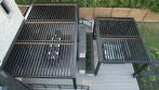 Backyard Pergola - photo 7 Top view of two black louvered pergolas with open louvers: a 27' x 17' dining pergola and a 17' x 14' pergola over the hot tub