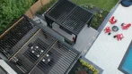 Backyard Pergola - photo 8 Black aluminum pergola with open louvers above a dining table, and a second pergola beside the pool patio with red chairs around a fire pit