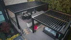 Backyard Pergola - photo 2 Aerial view of a modern backyard pergola design: two black louvered pergolas on a two-tier deck, dining area above and hot tub below